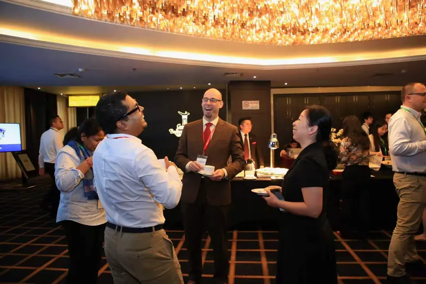 Johnny Browaeys in conversation at an industry networking event