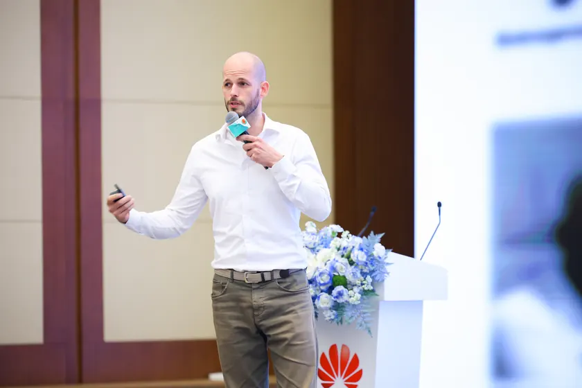 Nil Larom speaking at a corporate event